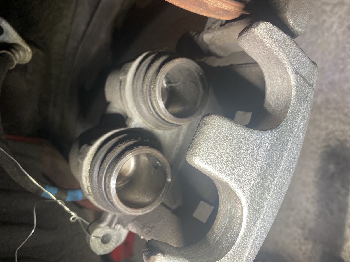 Clean dual-piston caliper with intact dust boots