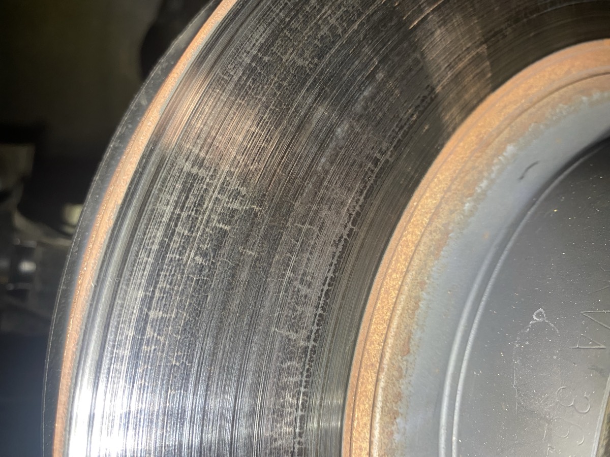 Scored OEM brake rotor after four track days