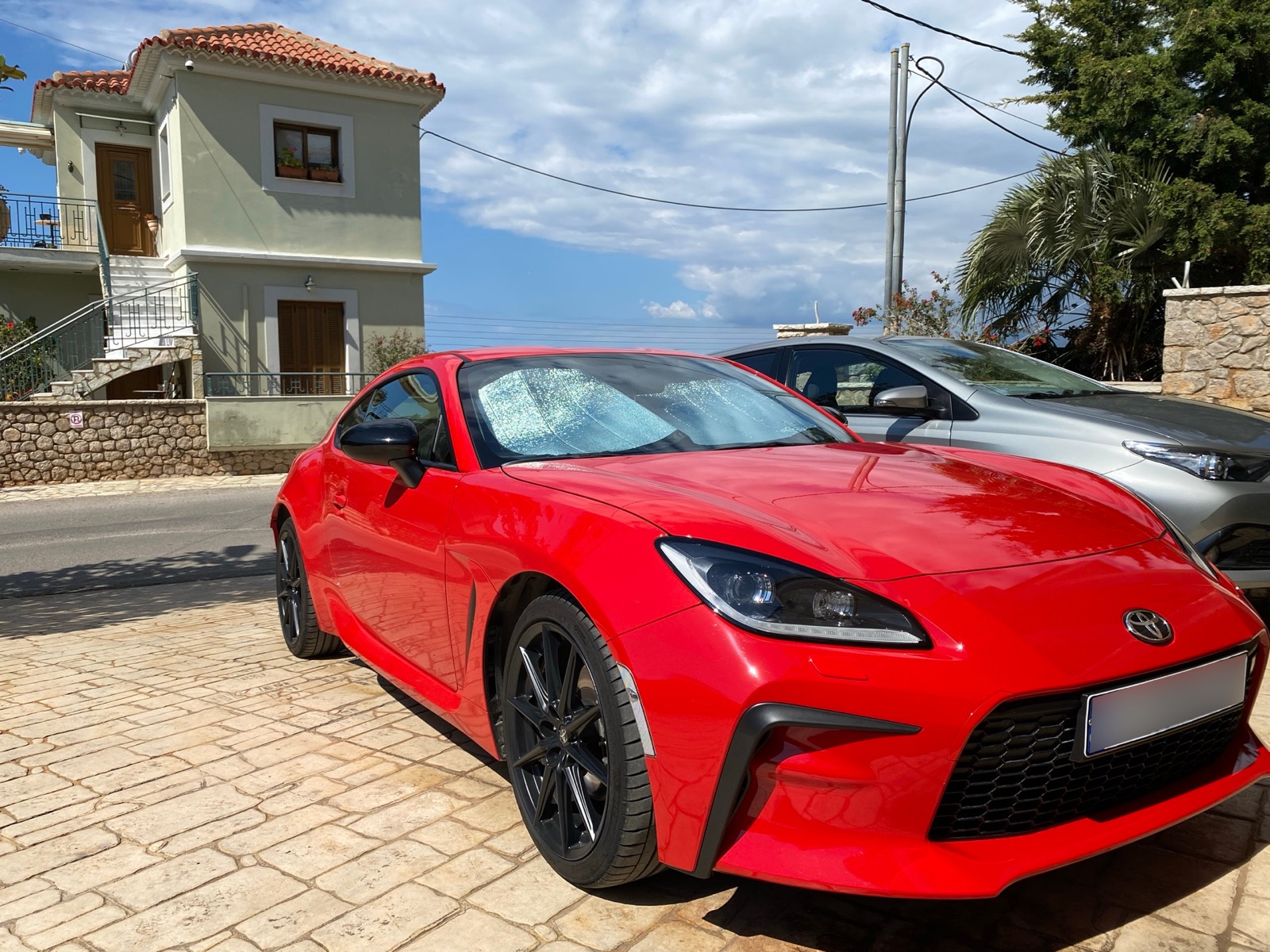 GR86 front three-quarter in a Greek coastal village