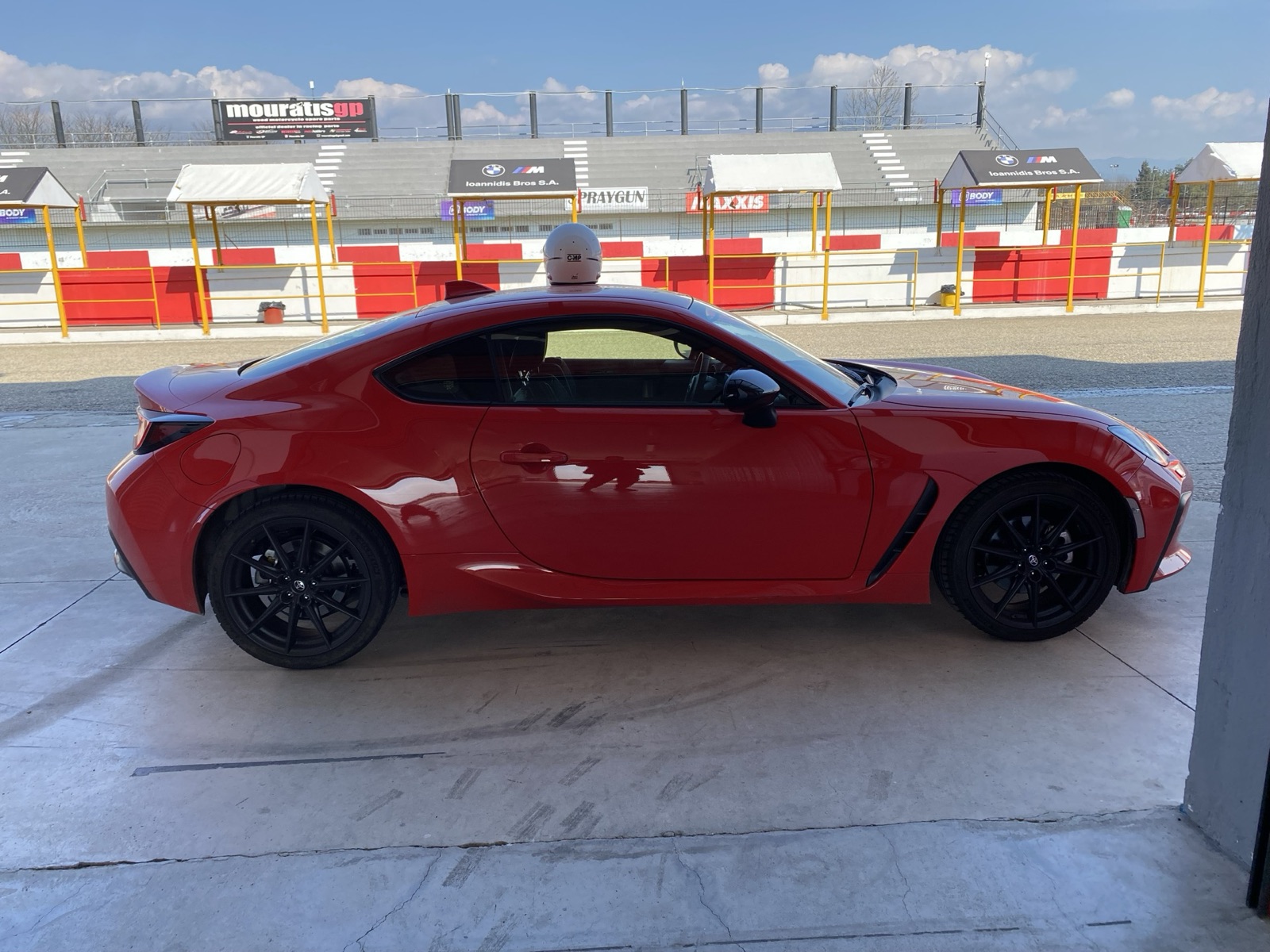 GR86 side profile in pit lane with garages behind